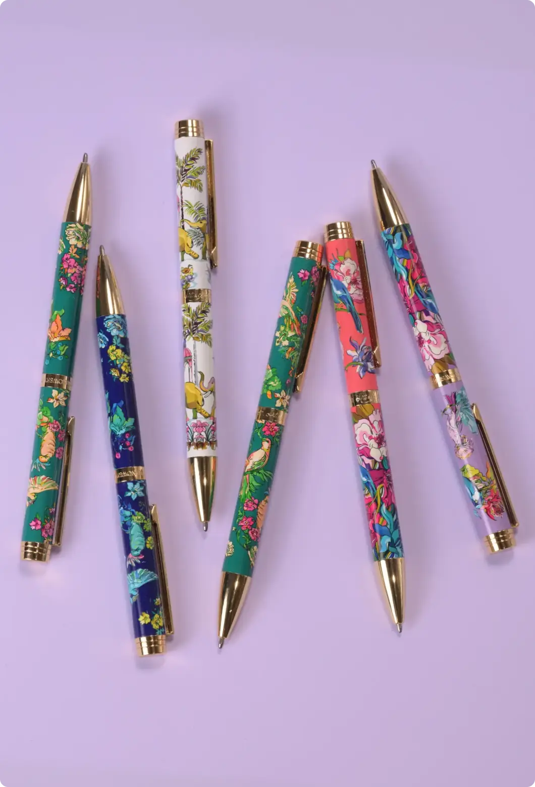 Set of six patterned ballpoint pens with tropical bird and floral surface designs